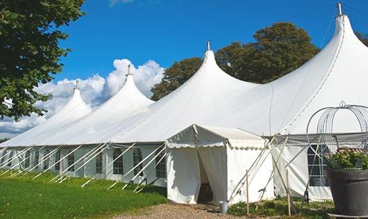 a group of luxury portable restrooms with individual stalls and running water in Dexter